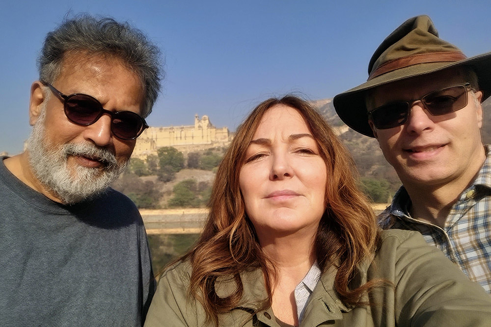Tushar Gandhi, Dr. Terry Oroszi, and Dr. David Ellis in Jaipur, Rajasthan, during the winter 2022-2023 Gandhi Legacy Tour. A hilltop Rajasthani fort is visible in the background.